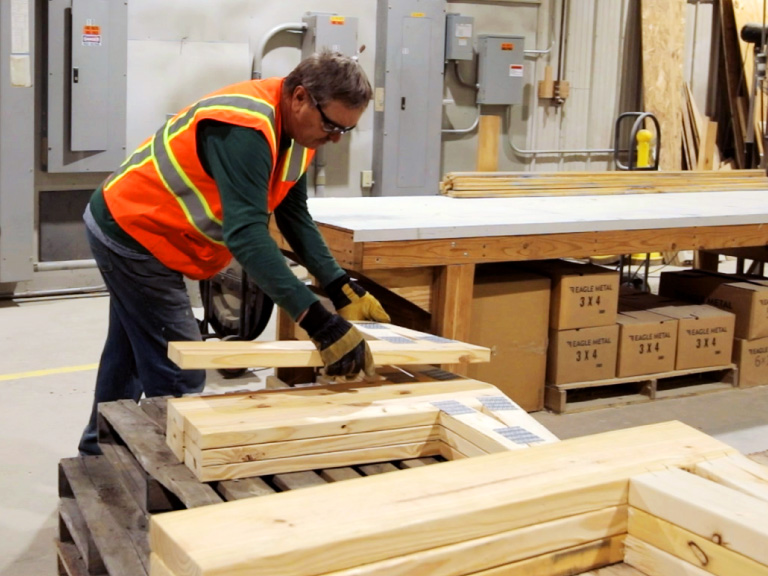 Walters Buildings employee assembling building components in in-house manufacturing facility