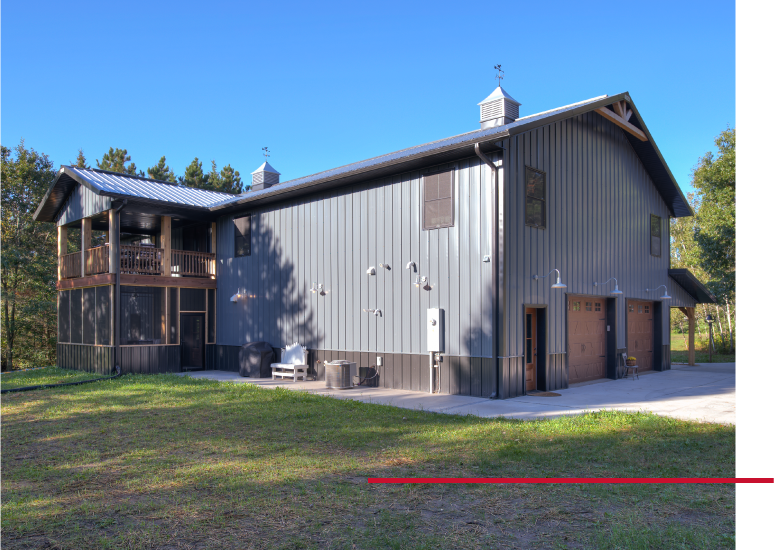 Luxury barndominium with garage doors and screened porch built by Walters Buildings