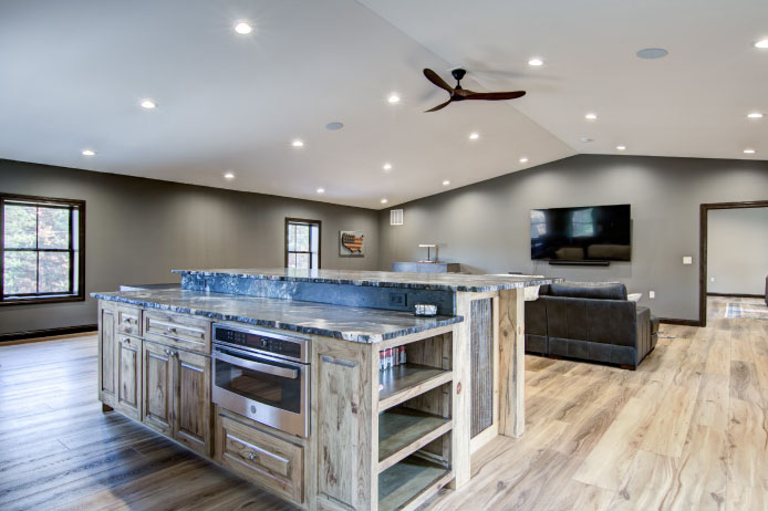 Barndominium Loft Entertainment Area with Custom Bar | Walters Buildings Barndominium loft entertainment area with custom bar and seating space