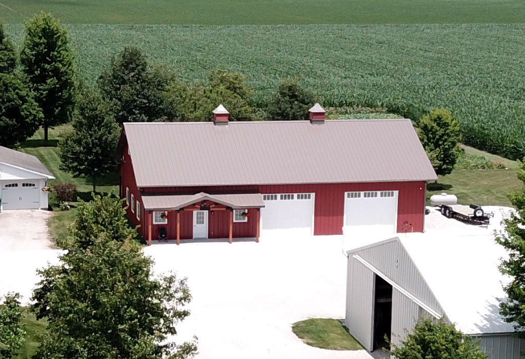Post Frame Barn with Porch and Cupolas Designed with Walters 3D Building Designer Post frame barn with steel siding, overhead doors, cupolas, and covered porch designed with Walters 3D building designer