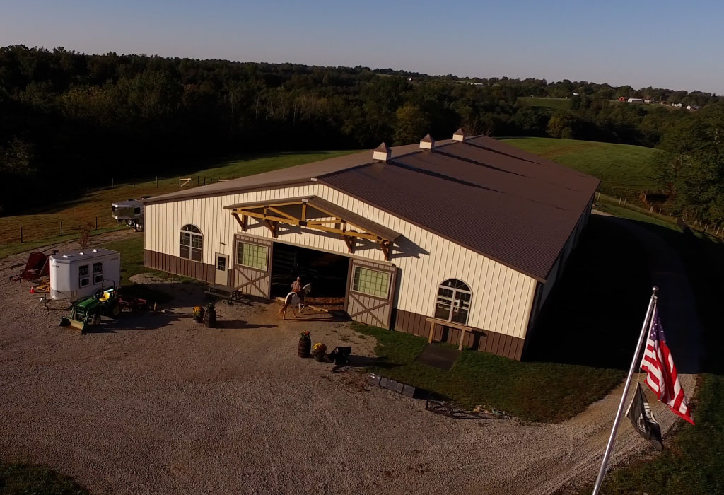 Custom Designed Horse Barn with Overhead Doors and Cupolas Custom post-frame horse barn designed for equine use with large overhead doors and cupolas