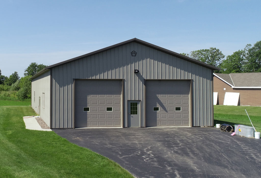 Steel Post-Frame Garage with Dual Overhead Doors and Walk Door Steel post-frame garage with two overhead doors and walk door for residential storage