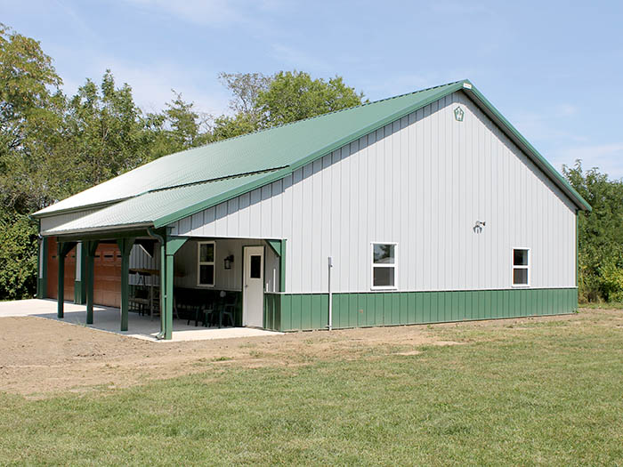 Post-Frame Garage with Covered Porch and Overhead Door Steel post-frame garage with covered porch, overhead door, and walk door