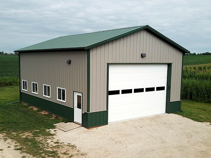 Agricultural Shop Building with Steel Siding and Overhead Door Steel post-frame agricultural shop building with overhead door, windows, and walk door