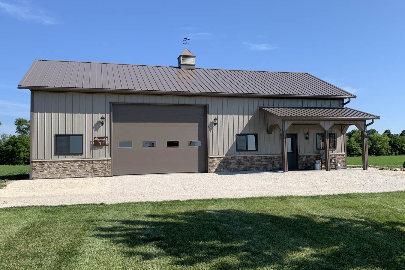 Residential workshop with steel siding, stone wainscot, overhead garage door, cupola, and covered porch 16' x 12' Haas 600 Overhead Door