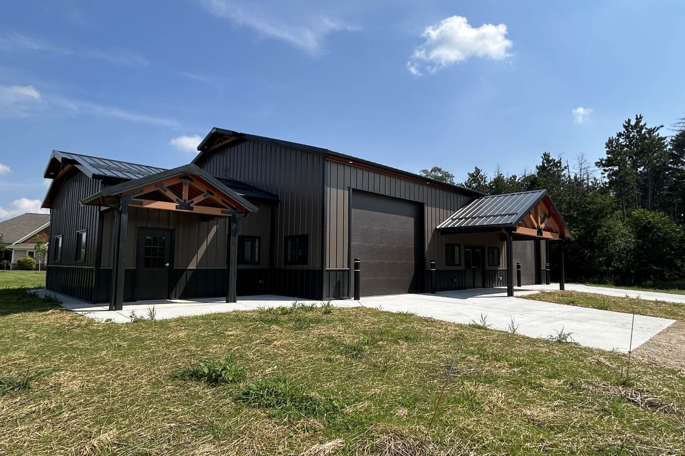 94 Gable entrance building with steel siding, dual cedar gable entries, and large overhead door