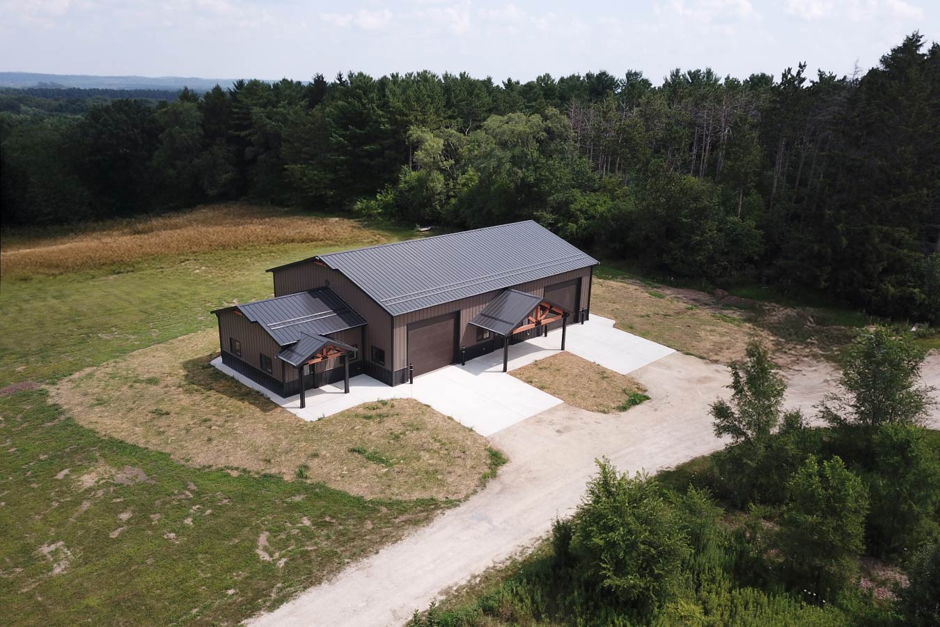 Gable entrance building aerial view with steel siding, steel roof, dual cedar entries, and concrete apron