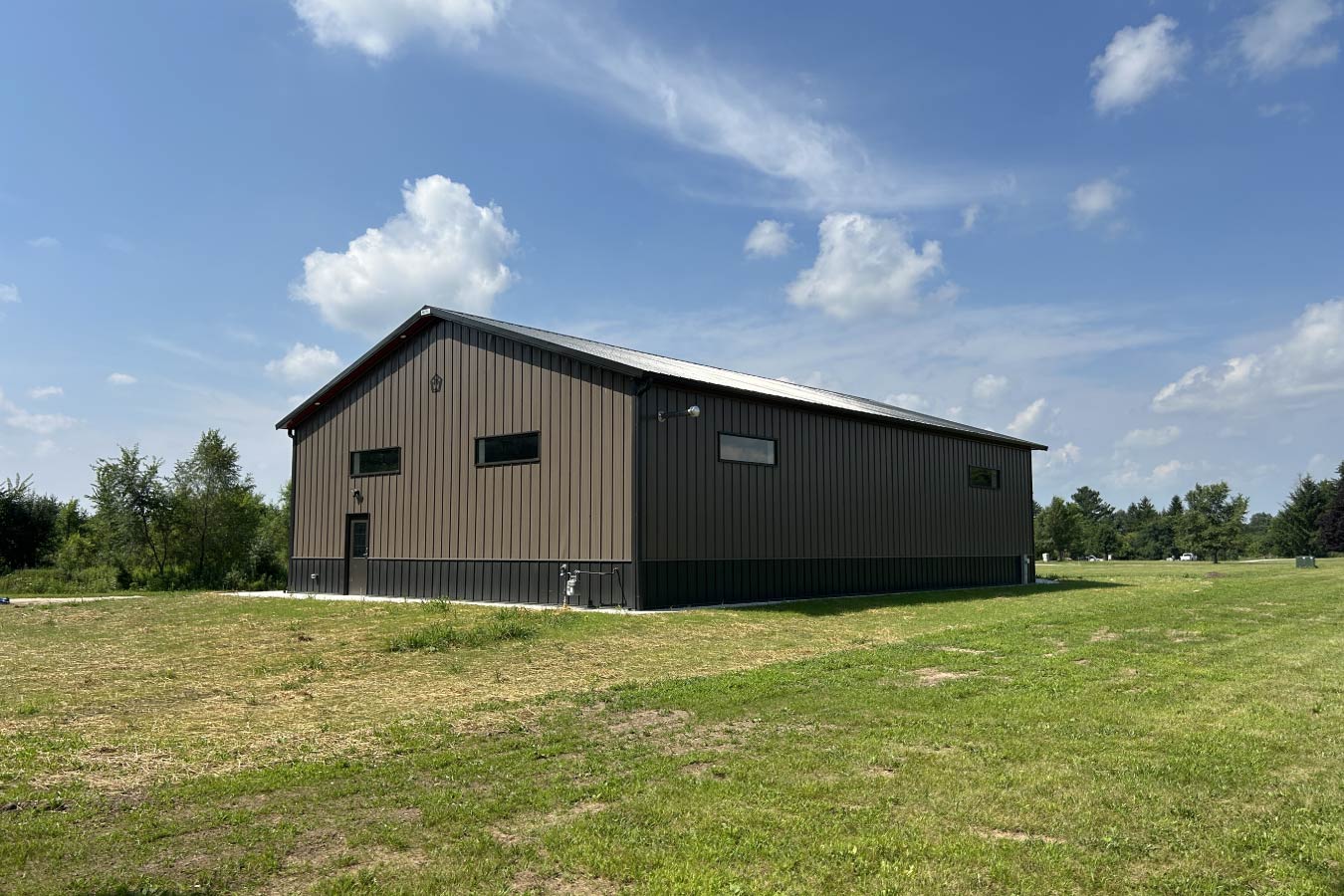 Gable entrance building with steel siding, steel roof, and horizontal Plyco windows