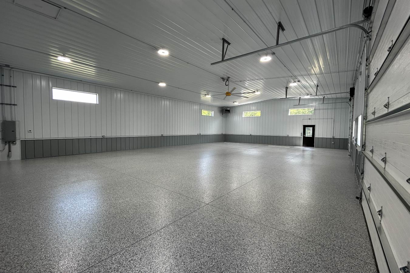 Interior of gable entrance building with finished steel liner, epoxy floor, and overhead garage doors
