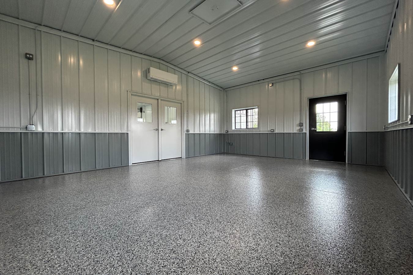 Interior office space in gable entrance building with epoxy floor, steel liner panels, and mini split system