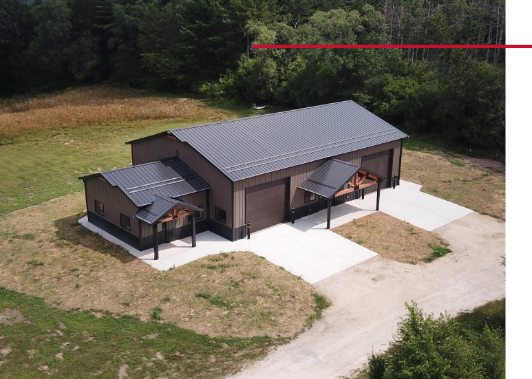 Gable Entrance Building Aerial View with Timber Frame Porches | Walters Buildings Aerial view of gable entrance building with timber frame porches, steel siding, and concrete drive