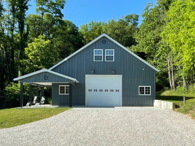 Custom post-frame building in Fairfield Illinois with metal siding, overhead garage doors, and concrete driveway