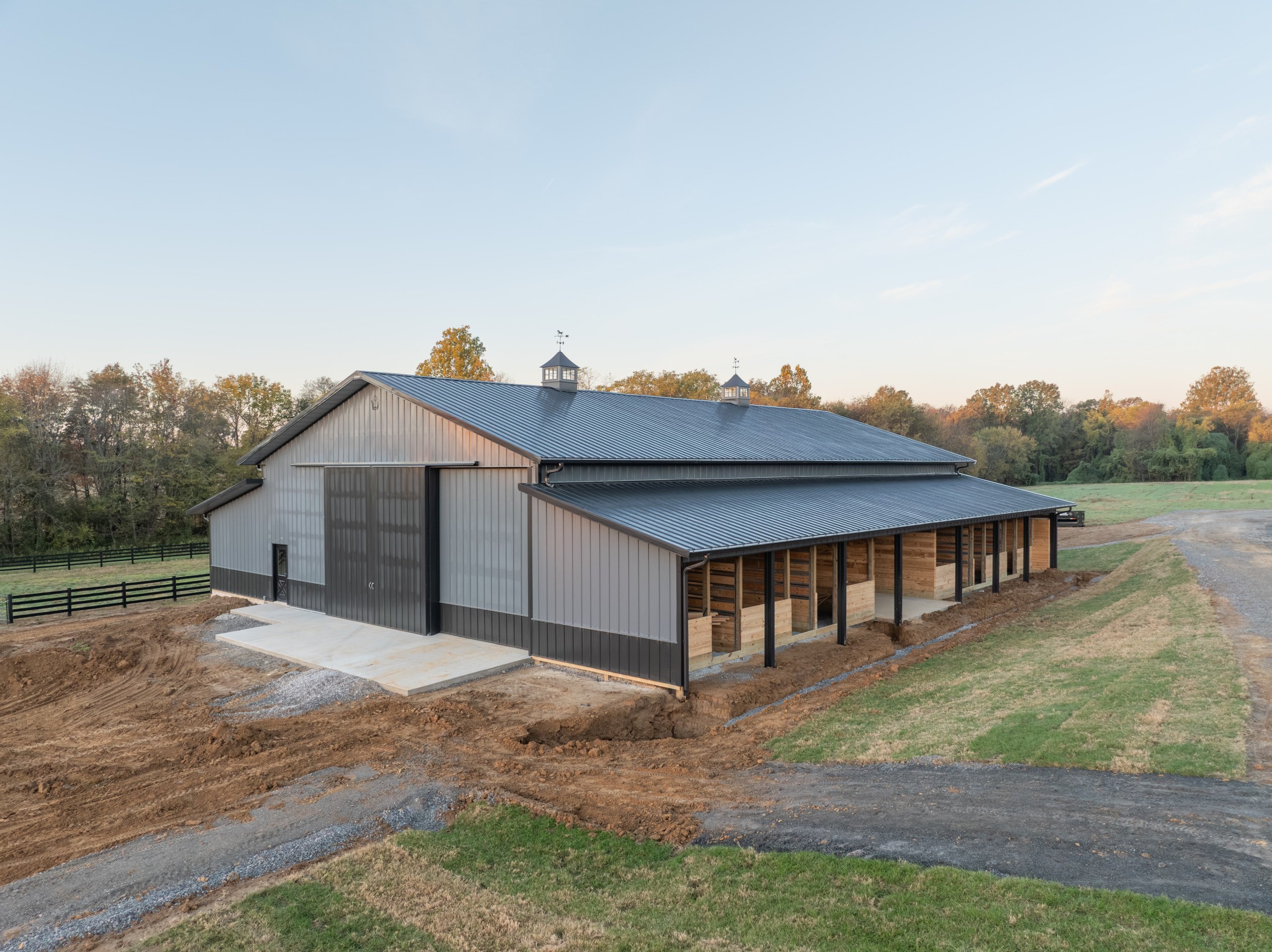 Monitor-style horse barn at The Settlement Equestrian Center with additional stalls and storage space