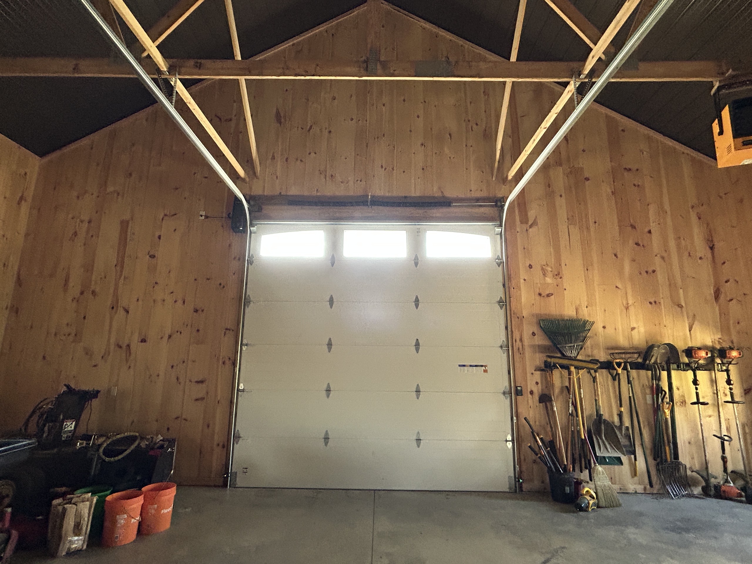 Interior overhead door view inside a 36' x 72' board and batten post-frame workshop