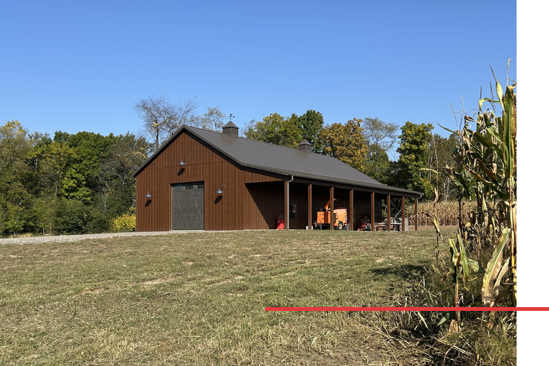 Distant View of 36′ x 72′ Board and Batten Pole Barn Distant view of a 36' x 72' board and batten pole barn with side porch and twin cupolas