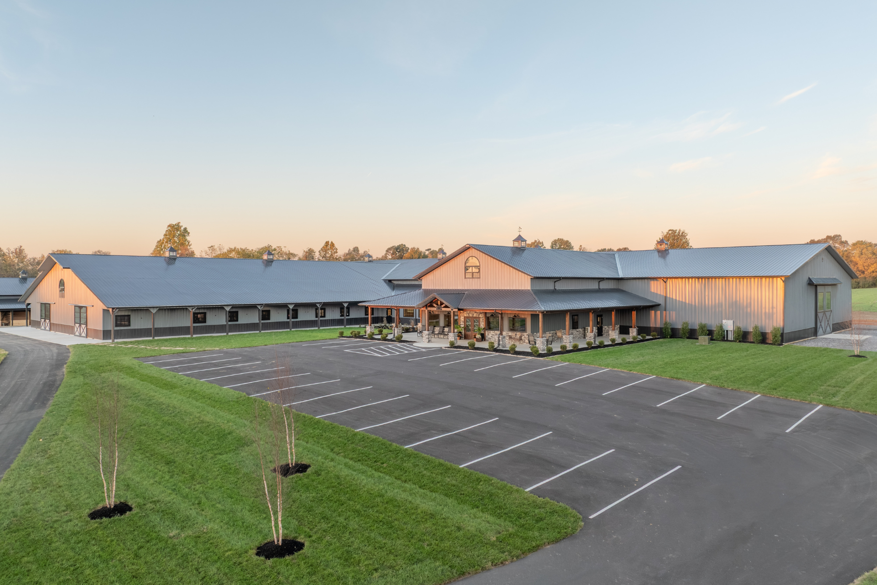 Custom equestrian center in Paducah, Kentucky with indoor riding arena, horse stall barn, and front office entrance