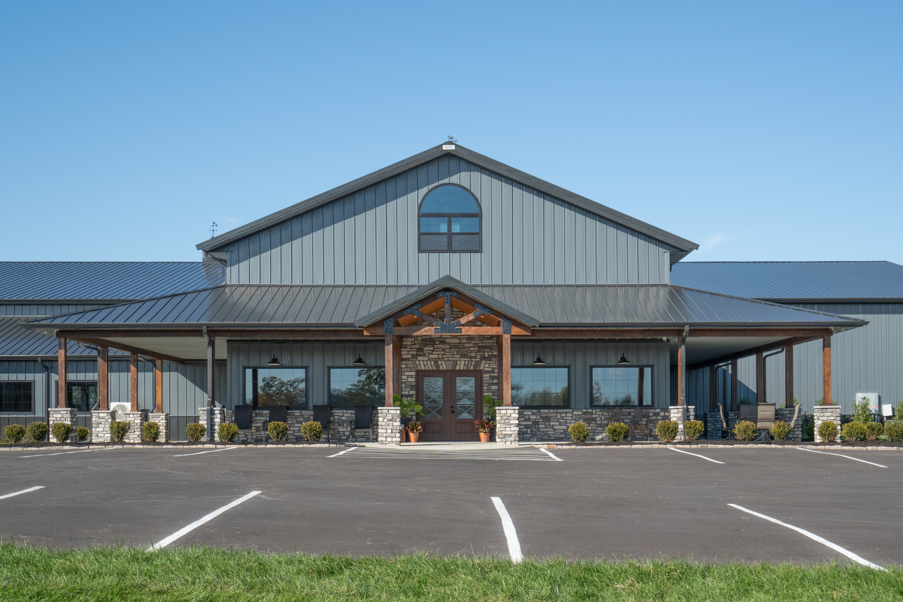 Front entrance of The Settlement Equestrian Center in Paducah, Kentucky with covered porch and commercial equestrian facility design