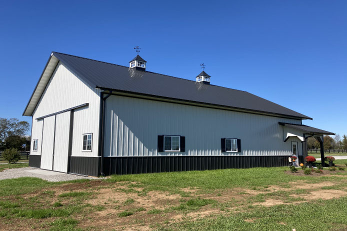 42×63 post frame building with cupolas, vertical metal siding, and landscaped front entry 42x63 post frame building with cupolas, vertical metal siding, and landscaped front entry