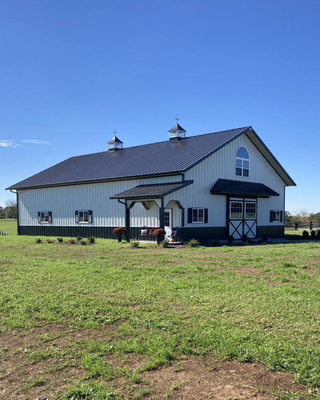 42×63 post frame workshop with white siding, black trim, and barn-style double doors with windows 42x63 post frame workshop with white siding, black trim, and barn-style double doors with windows