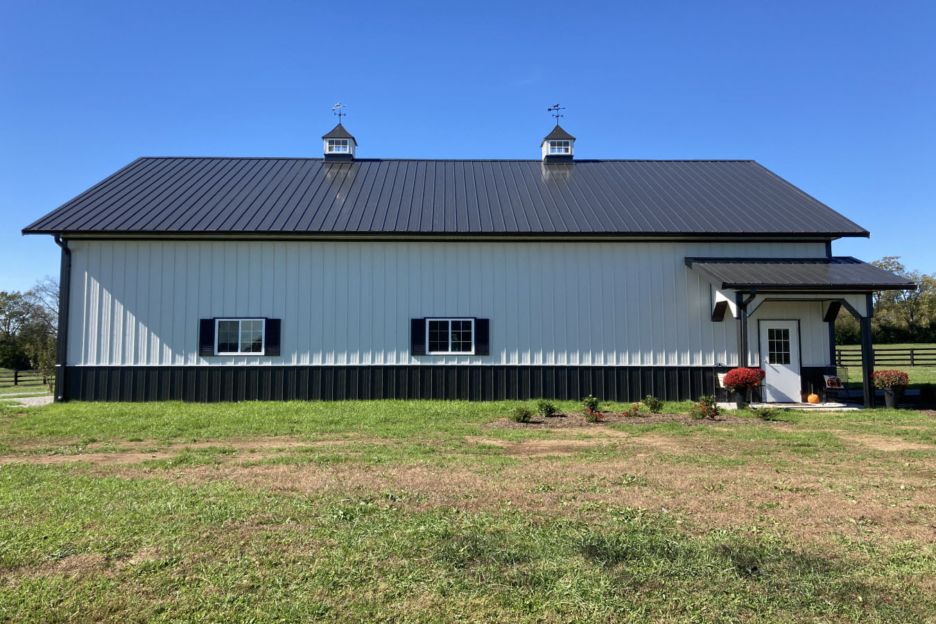 Front elevation of 42x63 post frame workshop with arched window and symmetrical barn doors