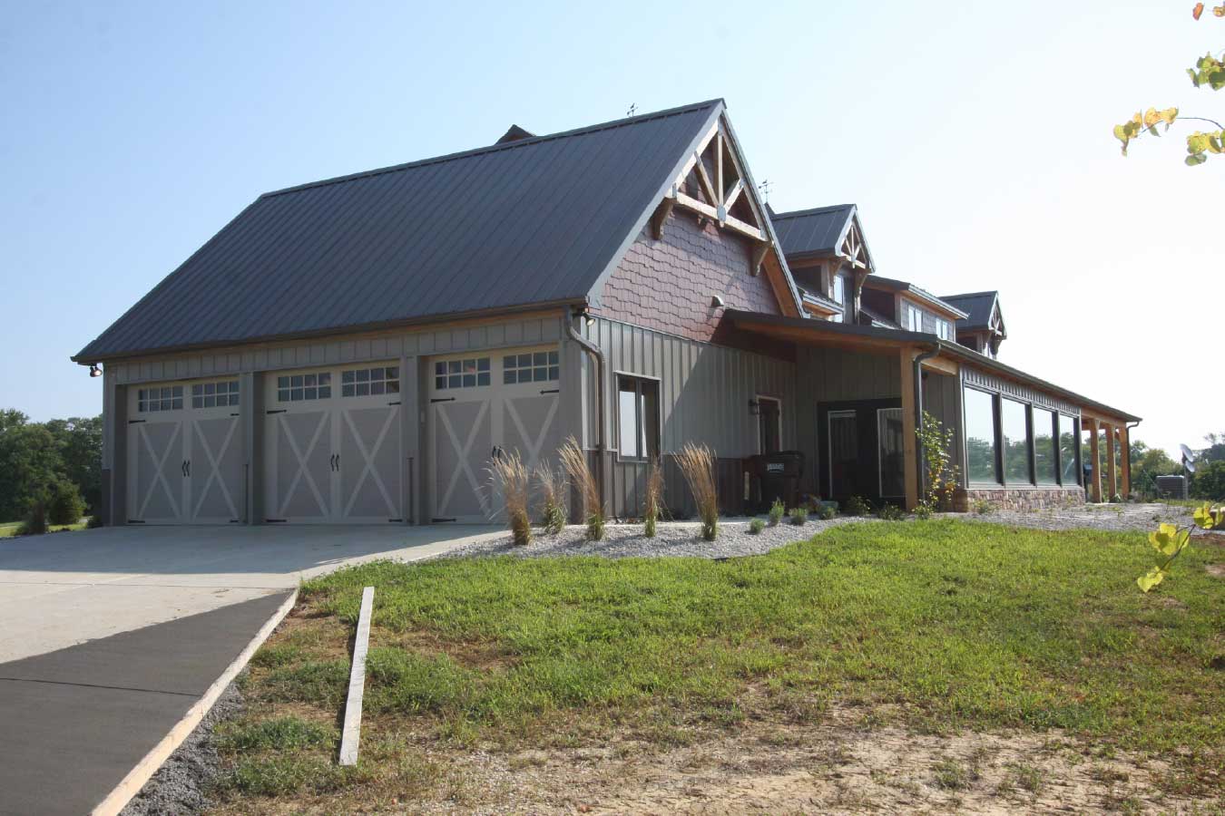 Attached three-car garage on a luxury timber frame post-frame home.