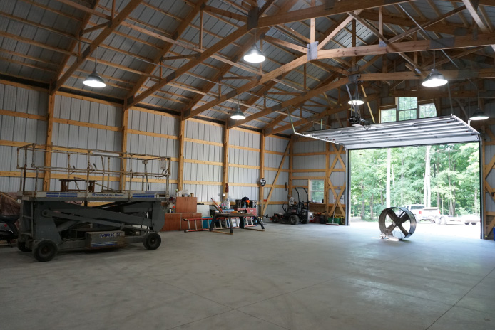 42×64 Pole Barn Interior with Clear-Span Workspace | Walters Buildings 42x64 pole barn interior with clear-span trusses, concrete floors, LED lighting, and oversized overhead door