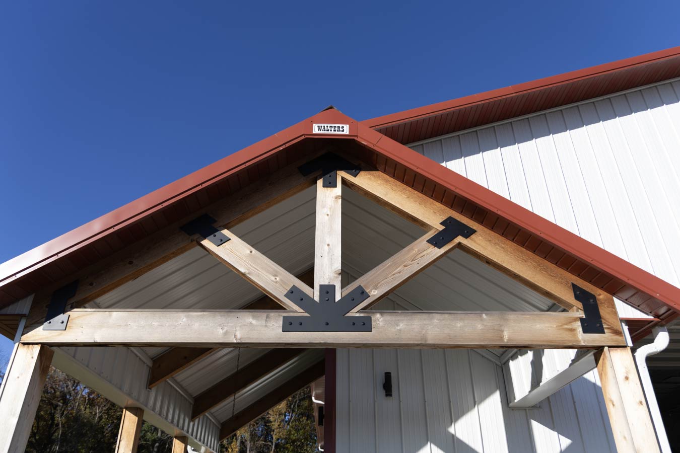 Agricultural equipment storage interior featuring tractors, shelving units, and wide overhead door access for easy movement