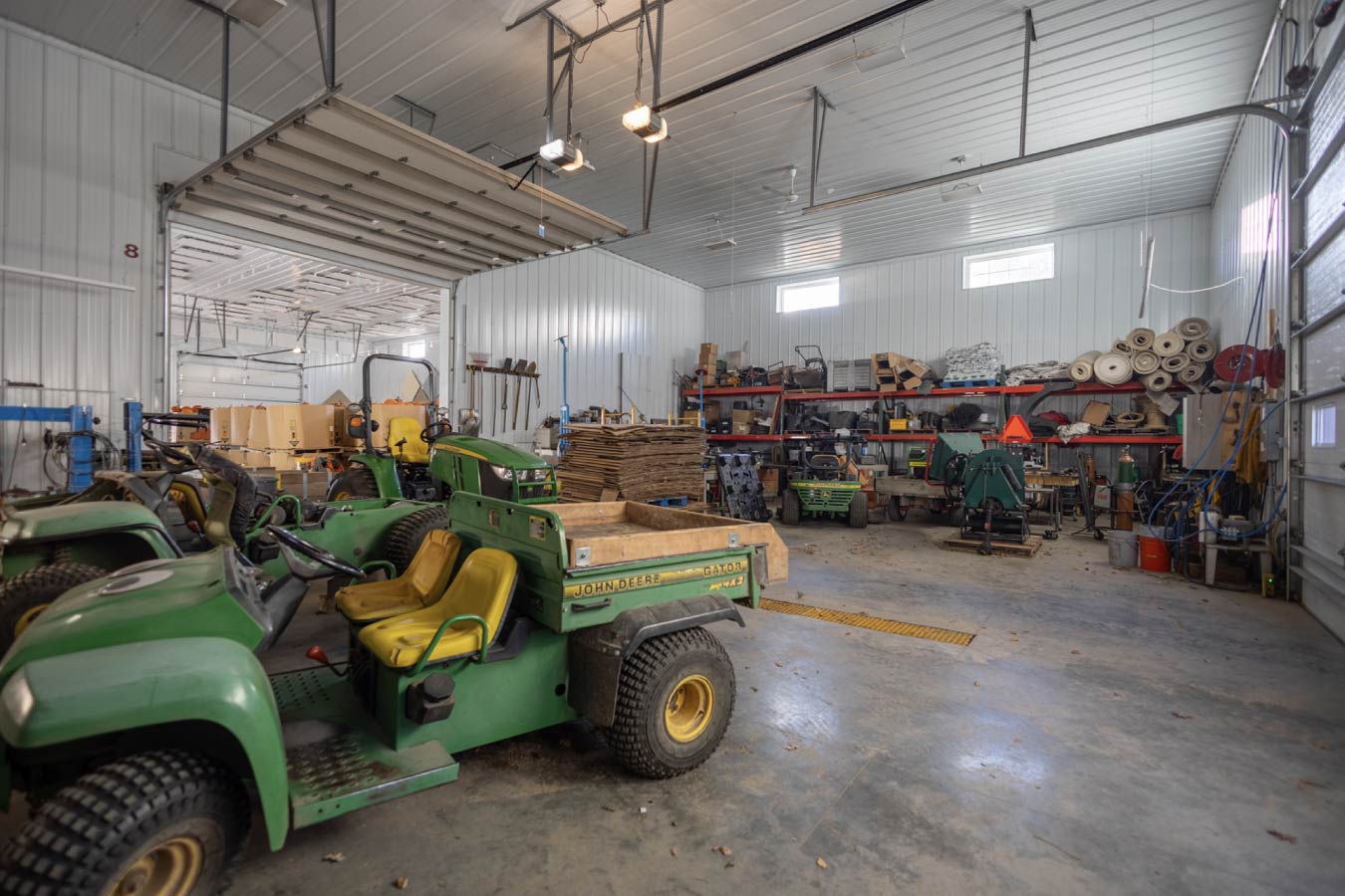 Farm market storage space with stacked produce bins, pallets, and open floor layout designed for handling and distribution