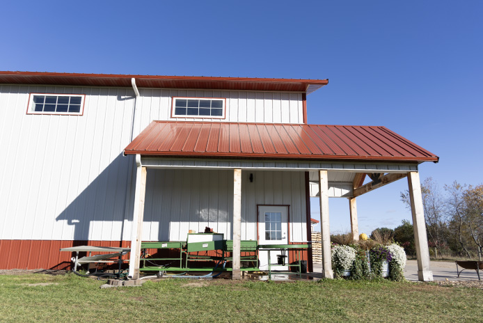 Interior of post-frame building with high ceilings, bright lighting, and open workspace designed for efficient agricultural storage and farm market operations Interior of post-frame building with high ceilings, bright lighting, and open workspace designed for efficient agricultural storage and farm market operations