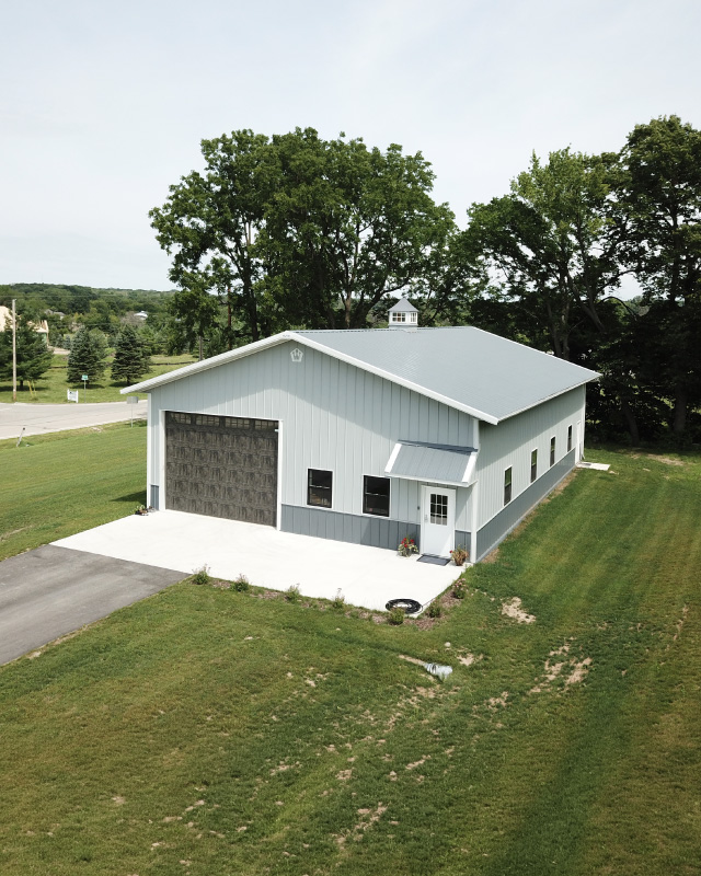40×60 Pole Barn Workshop with White Steel Siding | Walters Buildings 40x60 pole barn workshop with white steel siding, gray roof, and overhead garage door