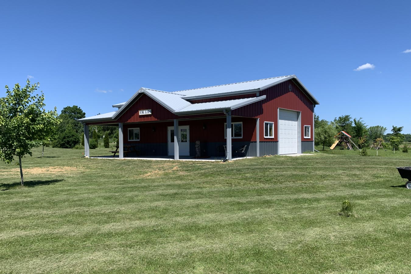 30x40 red pole barn garage with covered porch white steel roof and detached post frame construction