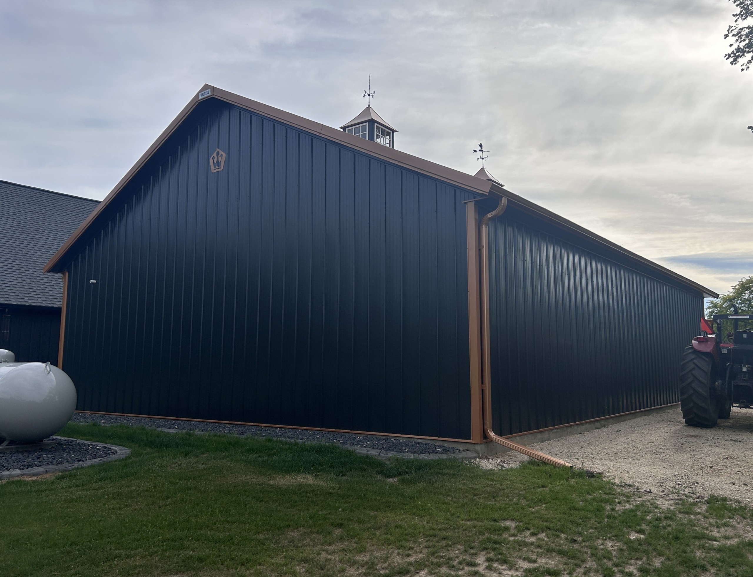 Rear view of a custom pole barn garage with steel siding and post-frame construction by Walters Buildings