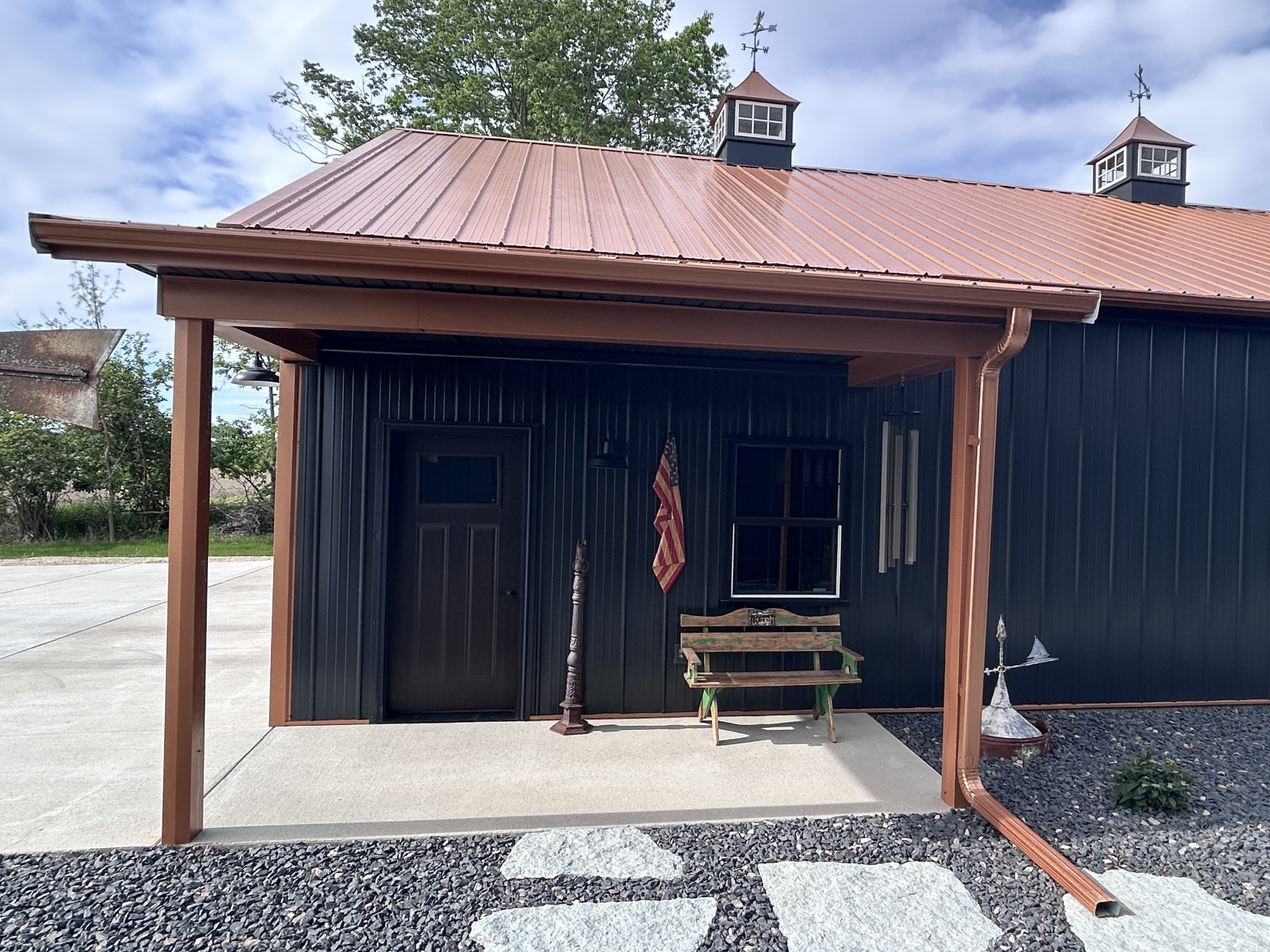 12-foot side porch on a 36x50 post-frame metal garage with 8'10" porch height and walk door by Walters Buildings