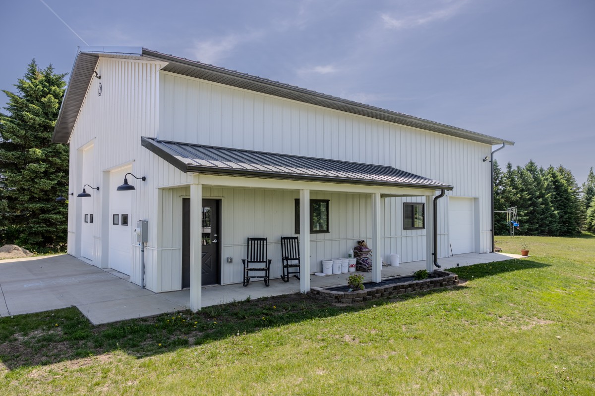36x50 post-frame garage in Jordan, Minnesota with white steel siding, covered porch and three overhead doors