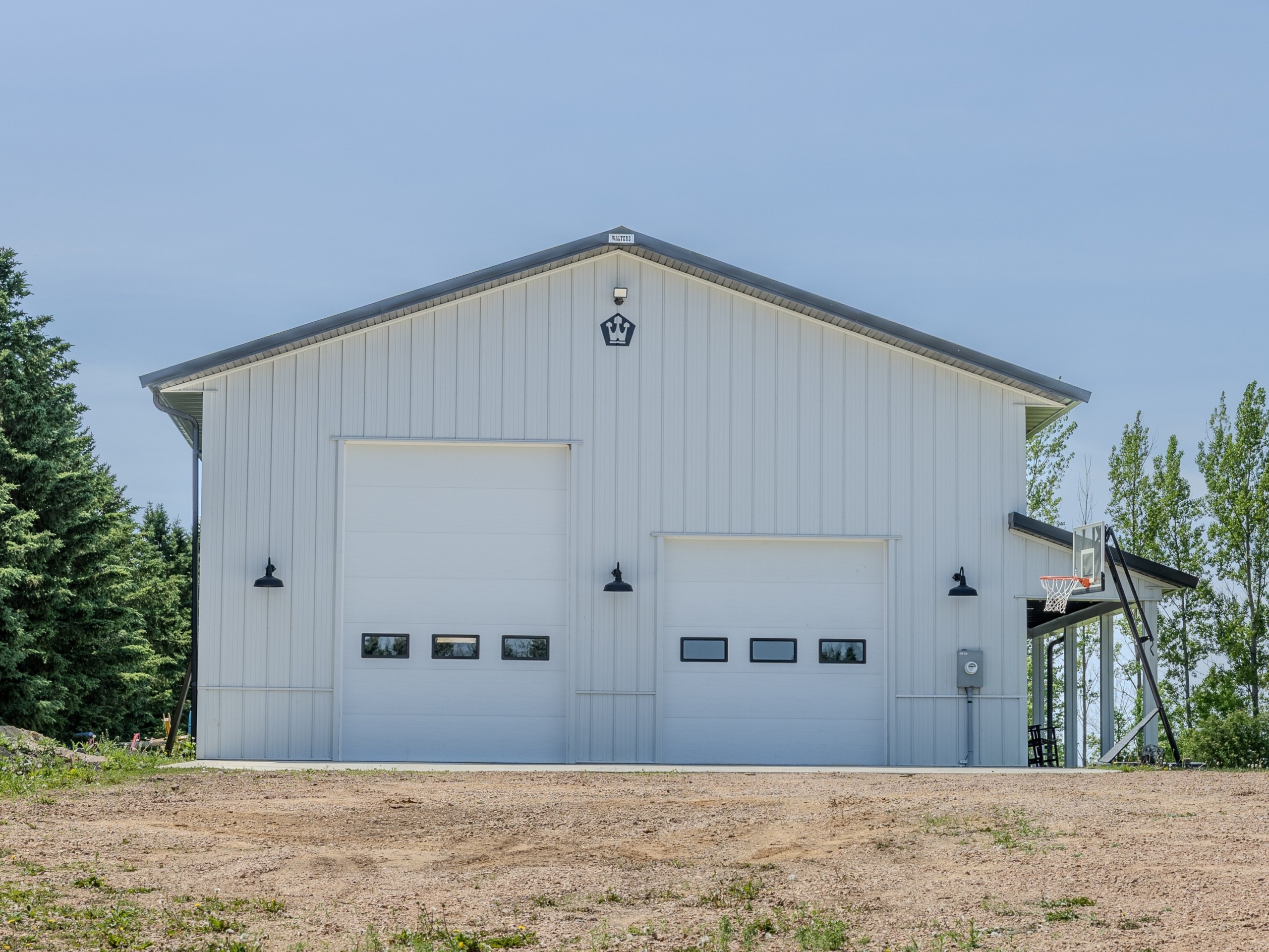 Front view of a 36x50 pole barn garage with 10x14 and 10x10 insulated overhead doors